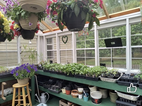 very happy customers showing off the new greenhouse