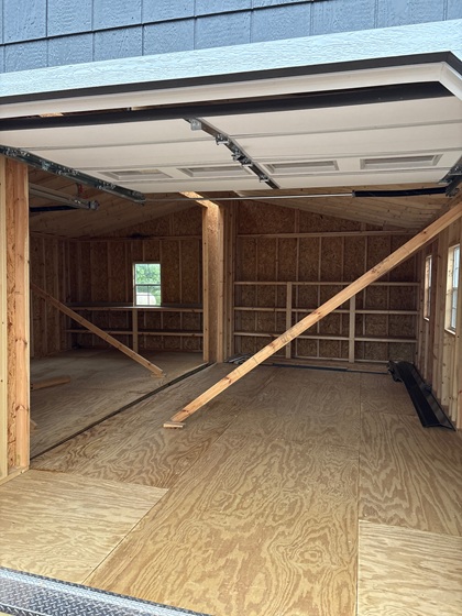 24x24 double wide garage with workbench and shelves inside