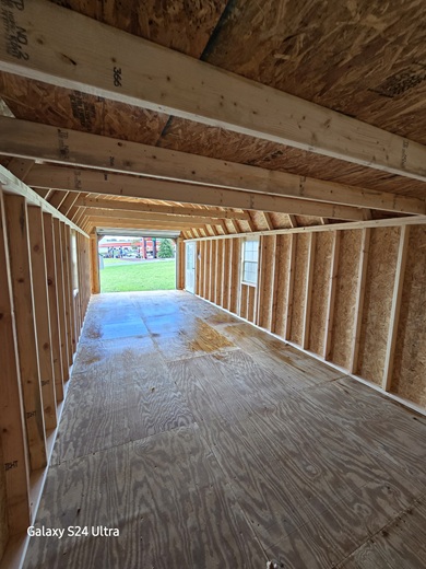 look inside 12x32 lofted barn with 9 foot garage