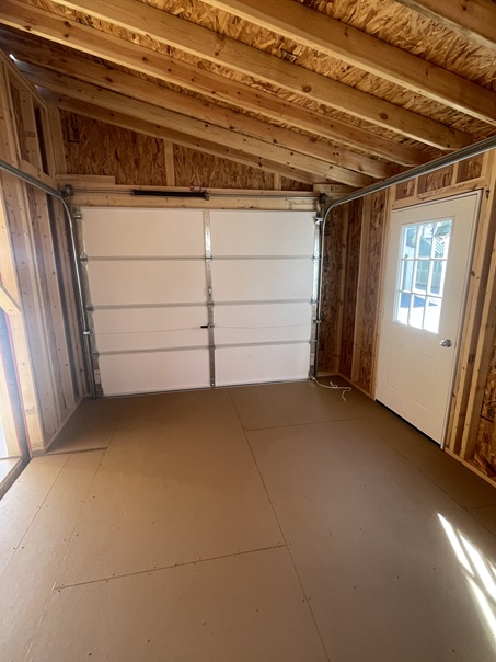 24x24 double wide garage with metal siding and 8 foot walls and garage doors